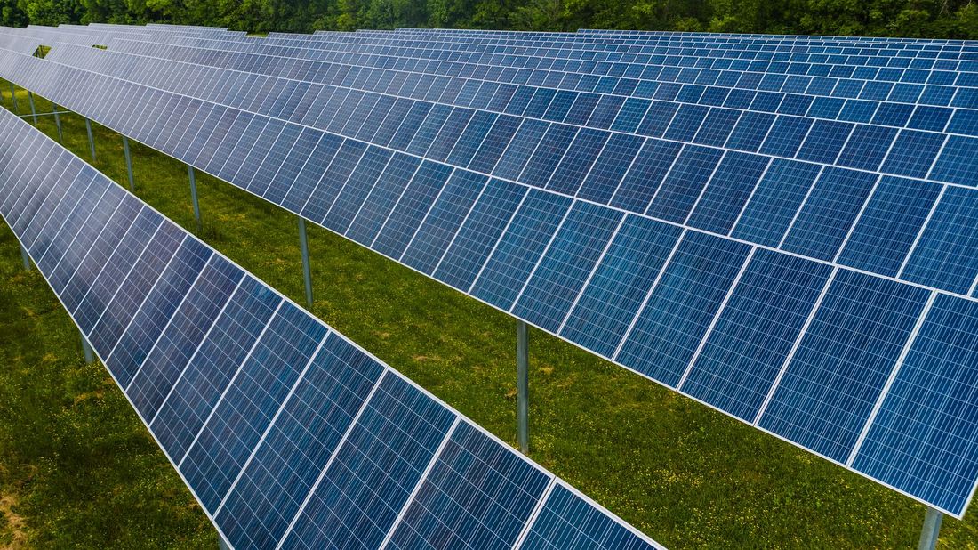 Rows of solar panels on a ground-mounted plant